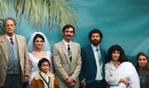 Familienportrait vor einer Palmentapete